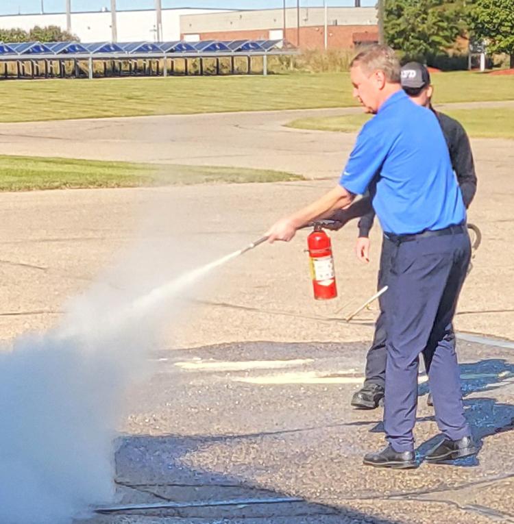  Steele-Waseca Finance Division Manager Jon Stelter utilized the fire extinguisher to put out a fire prepared by the firefighters.